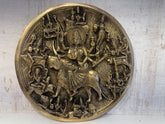 Detailed brass wall hanging showcasing Goddess Durga riding a buffalo, surrounded by other deities, depicting the Mahishasuramardini scene.